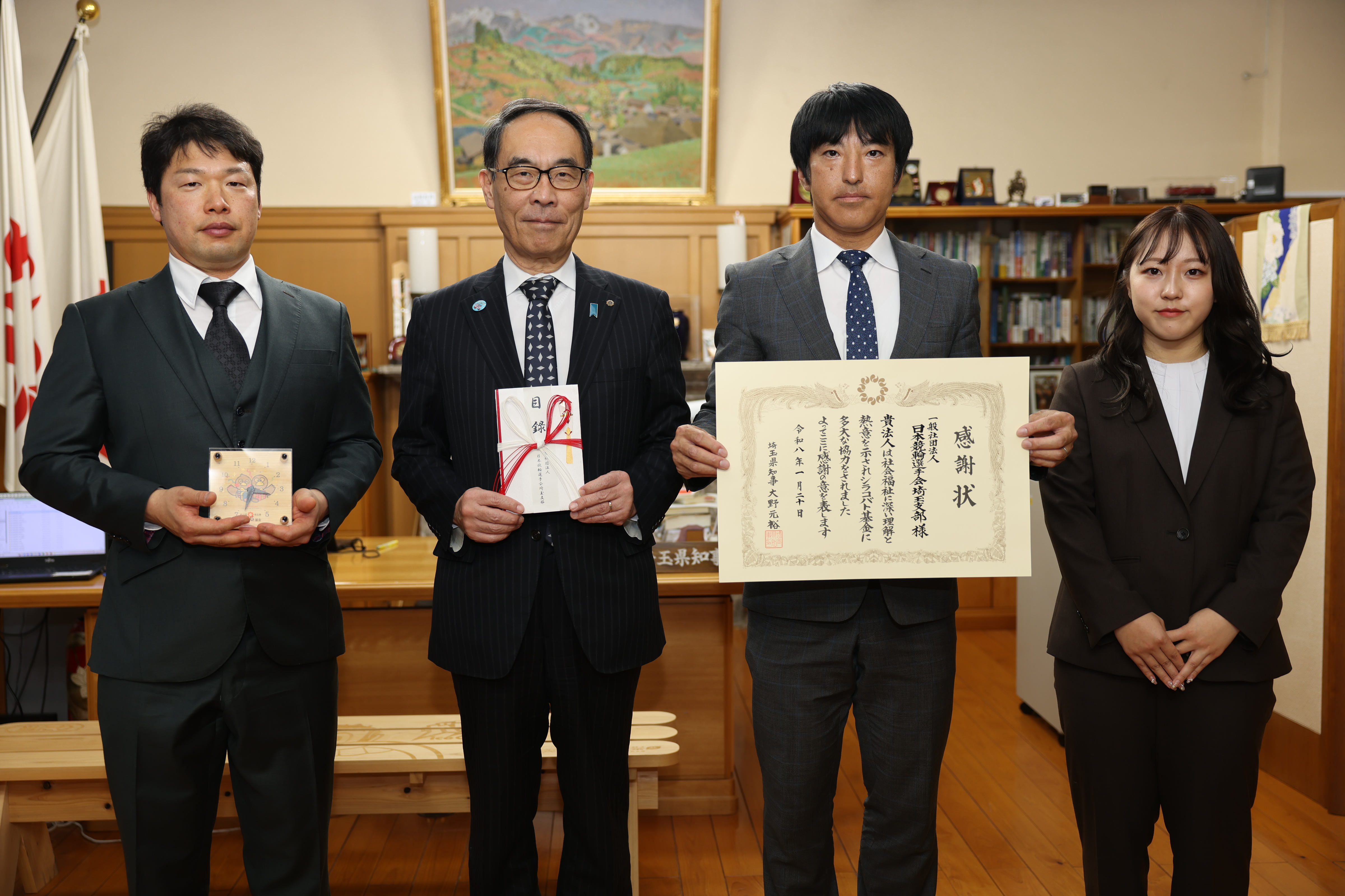 感謝状贈呈者と賞状や目録と一緒に記念写真を撮る知事の写真