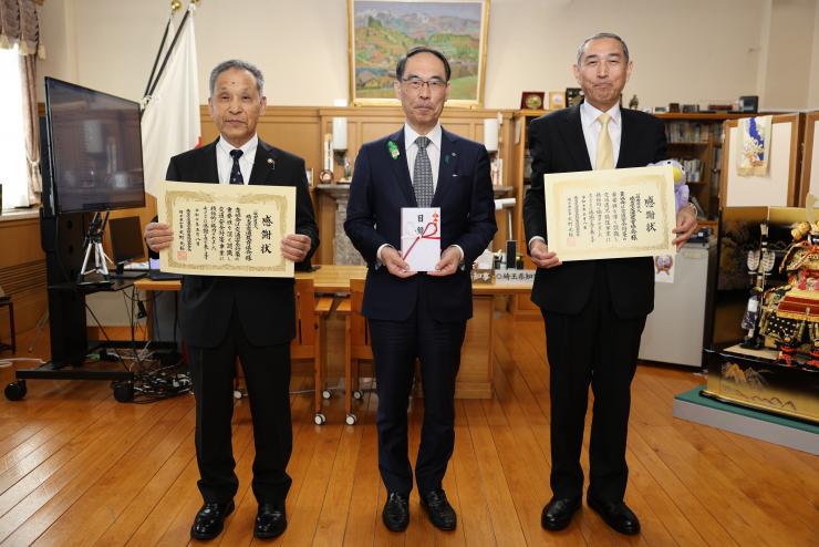 感謝状贈呈式で訪問者と記念写真を撮る知事の写真